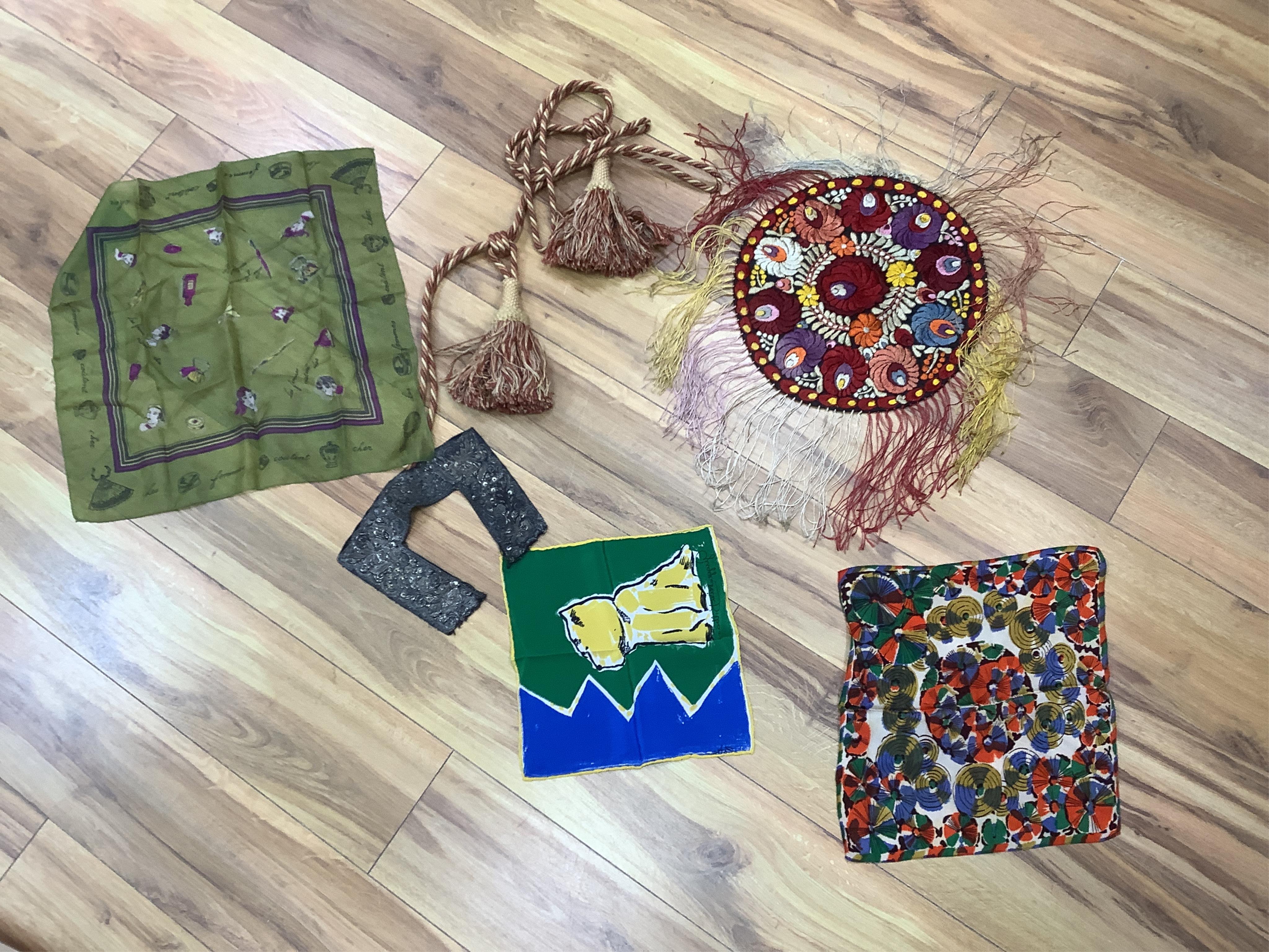 A collection of textiles: a ribbon work hankie and pyjama case, a metalwork collar, a coloured printed shawl, a nurses belt and embroidered belt, an advertising Guggenheim Bilbau hankie etc (10). Hankie case 22cm square.